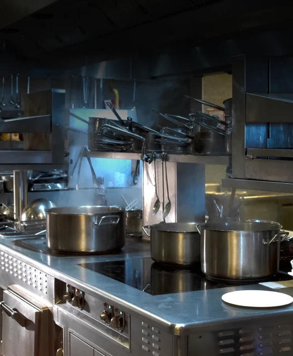 Industrial kitchen setup with stainless steel pots