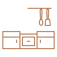 Minimalist kitchen setup with cabinets and hanging utensils.