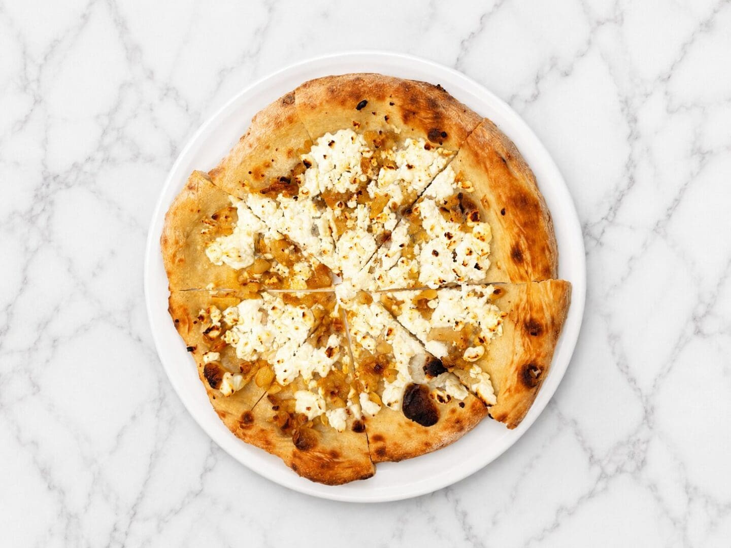 Thin-crust pizza with ricotta and caramelized onions