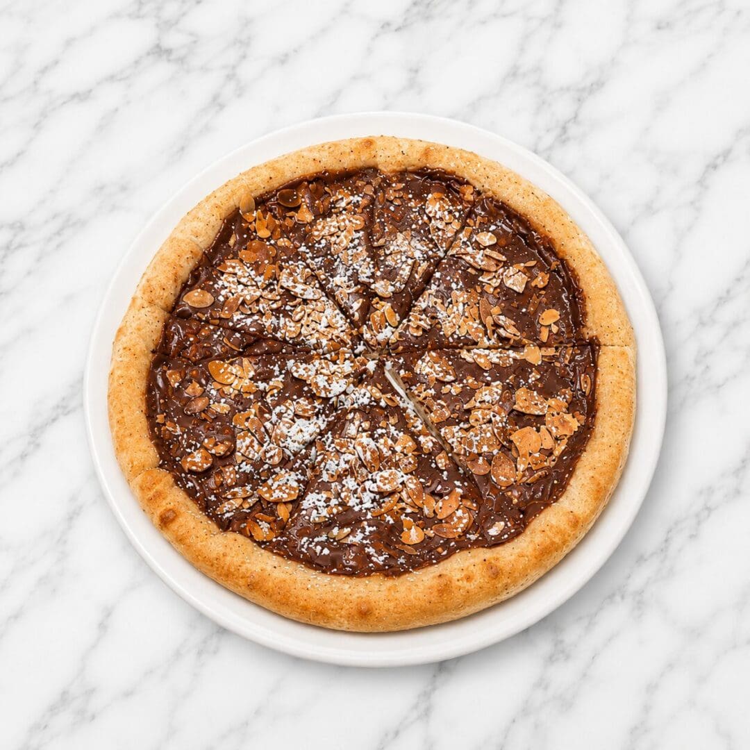 Chocolate almond pizza on white plate