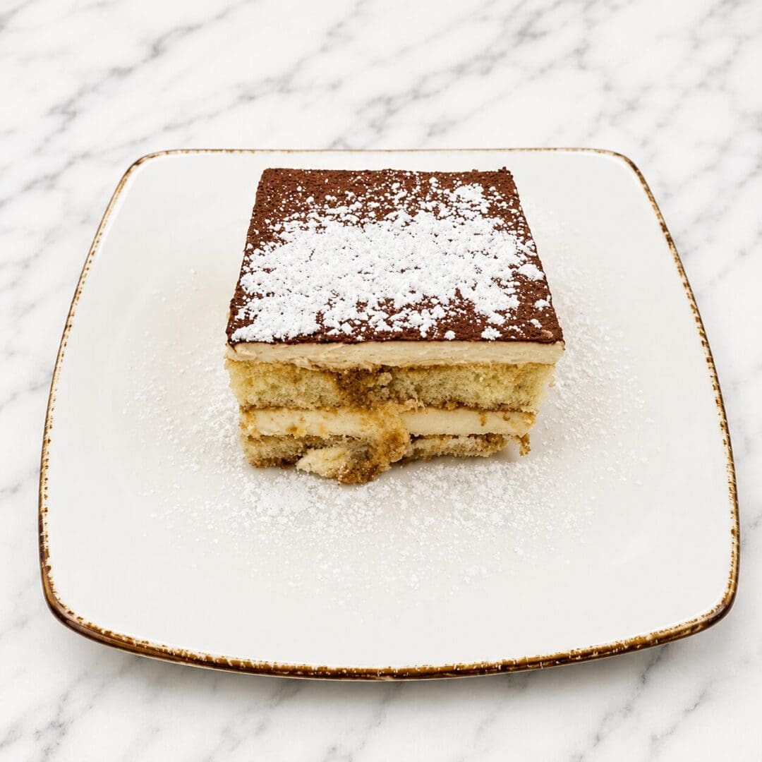 Square tiramisu dusted with powdered sugar