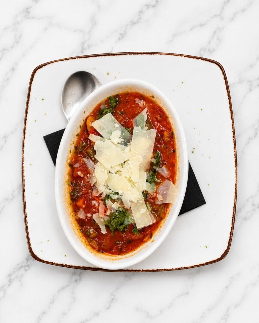 Tomato soup topped with shaved Parmesan