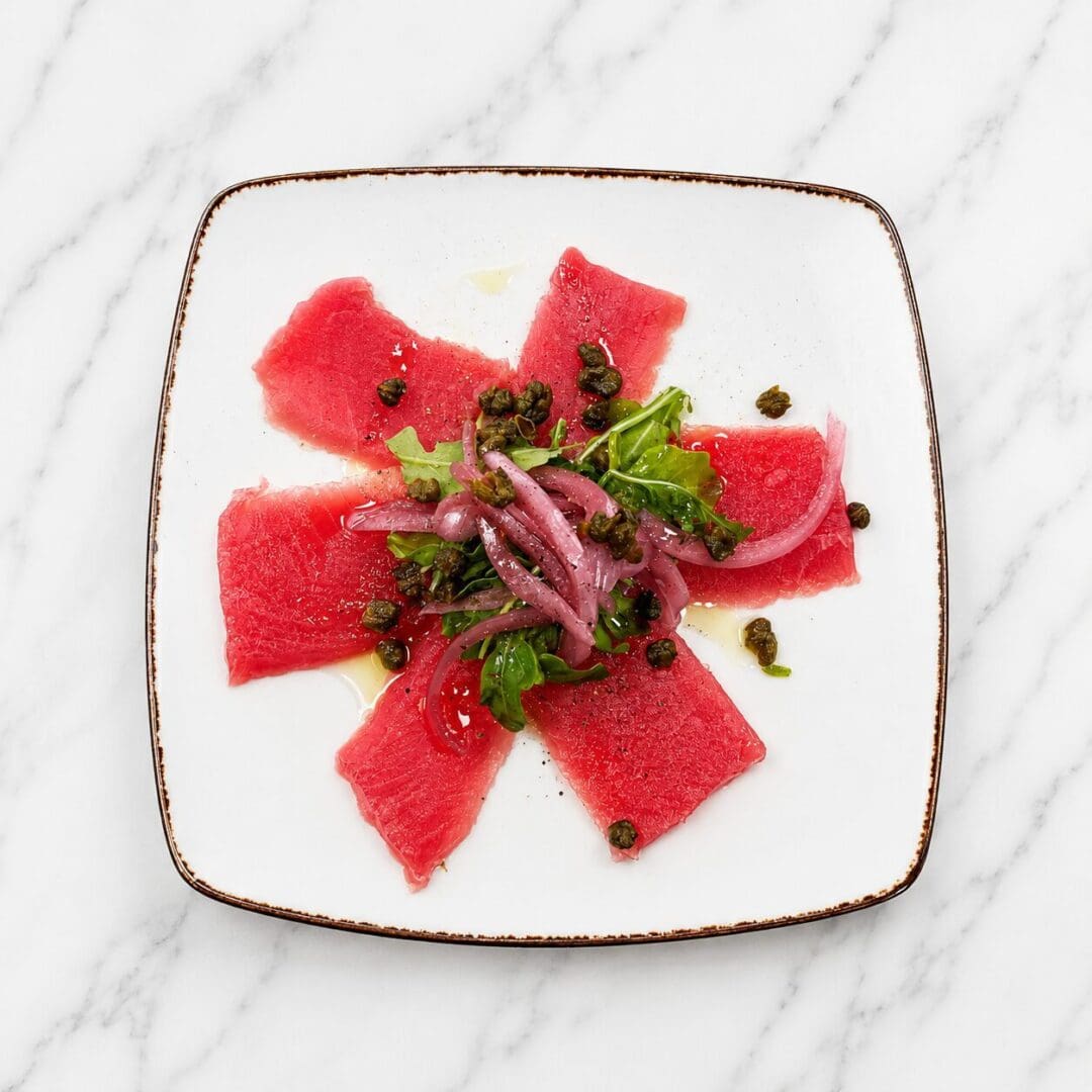 Tuna carpaccio with arugula and capers