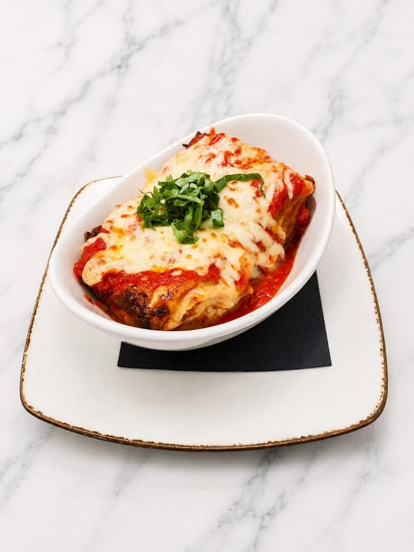 Baked lasagna with melted cheese and basil