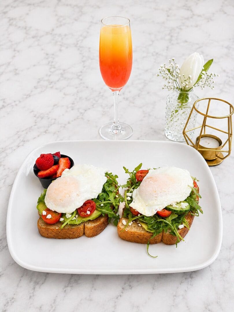 Avocado toast with poached eggs and mimosa